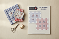 Summer Roses quilt pattern by Minick & Simpson styled with coordinating plaid fabrics and sewing notions