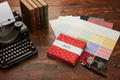Journal Basics layer cake squares styled on a vintage desk with typewriter, books, and fountain pen