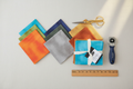 Nature's Bounty fat quarter bundle fanned out in earthy mottled tones with quilting tools