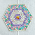Eggcellent Hexagon Table Topper handmade by Jo — clean white background showing pastel Easter egg fabric and embroidered chick center