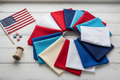 Honor Bella Solids Fat Quarter Bundle lifestyle photo — patriotic red, white, cream, and blue solid fat quarters styled with Americana accents